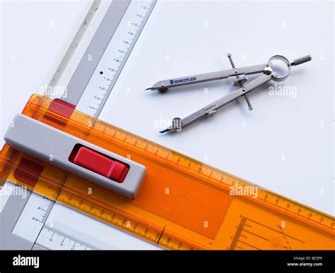 A Technical Drawing Board And T Square With A Pair Of Compasses Stock