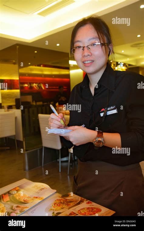 Waitress In Chinese Restaurant In High Resolution Stock Photography And