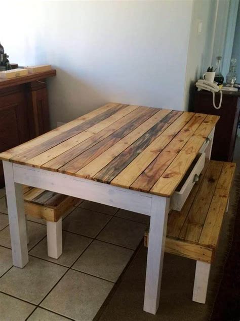 A white dining table with a tabletop made of a single pallet on thin metal legs is a bold contemporary idea. Pallet Dining Table and Bench - 101 Pallets