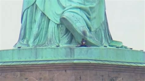 Person Sits At Statue Of Libertys Feet After Reported Climb Video