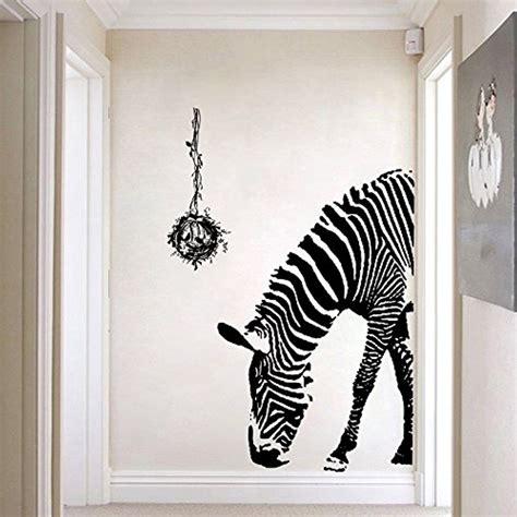 An Image Of A Zebra Eating Food On The Wall Next To A Clock And Door