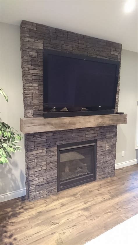 This fireplace is flanked on either side by storage cabinets, with both the cabinets and the firebox being framed by the same sage green stone veneer. Living Room Fireplace Featuring Stonecraft Stone Veneer ...