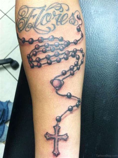 If you're looking for a rad font to go along with your cross tattoo, check our this curated collection: 52 Great Rosary Tattoos On Arm