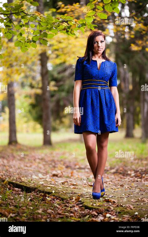 Brunette Girl In Blue Dress Walking At Park Stock Photo Alamy