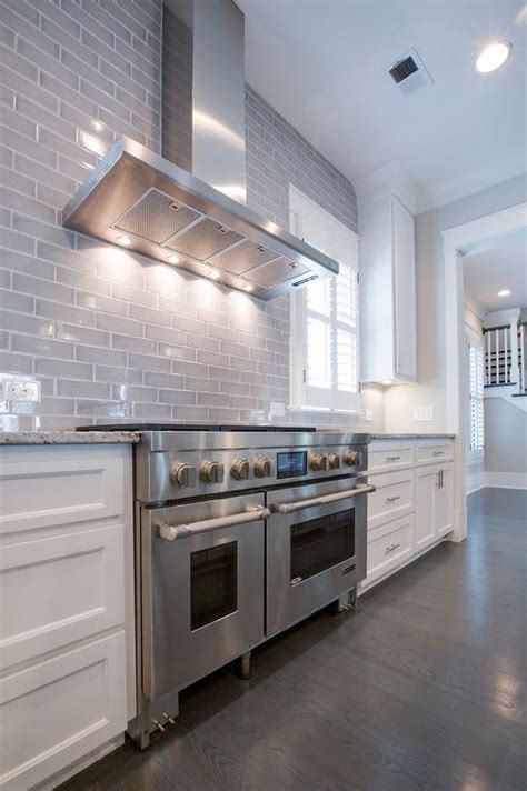 Choosing a marble backsplash for white cabinets means you are keeping the kitchen bright, but still with a bit of texture thanks to the grey coloring throughout. Kitchen with Gray Subway Tiled Backsplash - Transitional - Kitchen