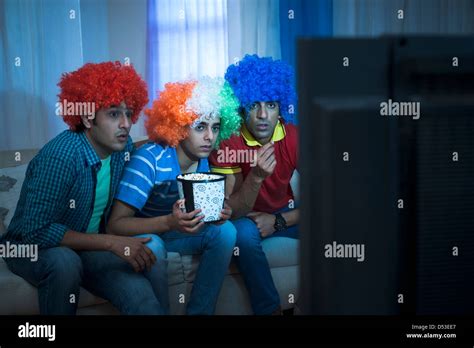 Friends Watching Cricket Match On The Television At Home Stock Photo