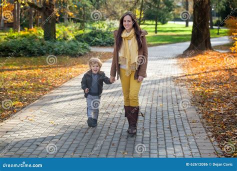 Happy Little Boy And His Mother Walking In Park Stock Photo Image Of