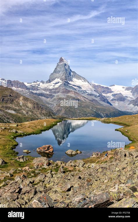 Hikers Admire The Matterhorn Reflected In Lake Stellisee Zermatt