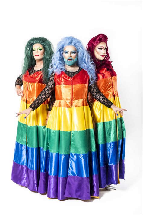 Drag Queens With Rainbow Dresses Standing Over White Background Stock Photo
