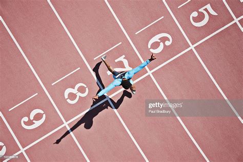 Runner Crossing Finishing Line On Track High Res Stock Photo Getty Images