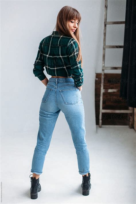 Young Sexy Woman In Blue Jeans Standing Back Looking Sexy By Stocksy