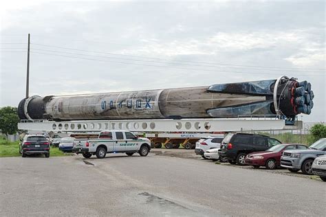 A Spacex Falcon9 Booster Being Transported Over The Road By The Rocket
