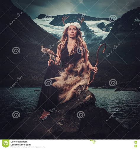 Nordic Goddess In Ritual Garment With Hawk Near Wild Mountain Lake In Innerdalen Valley Stock