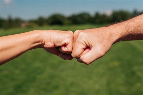 Free Photo Close Up Two Fists Hitting Outdoors