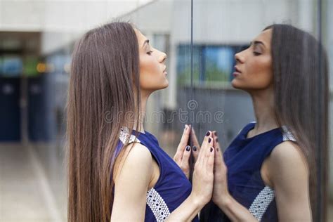 Stylish Lady In Blue Dress Posing Near Mirrored Wall Stock Photo