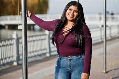 pretty latino xxl model girl from ecuador wear on violet blouse posed against lake 10501341