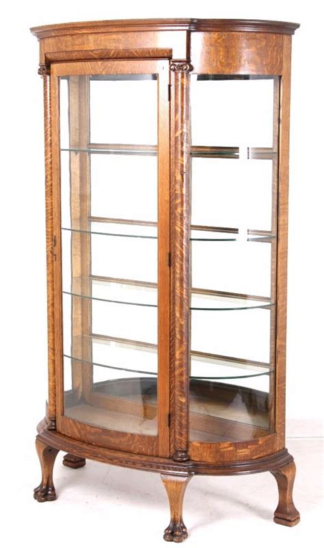 Cherished memories begin with a curio cabinet or glass display cabinet. Tiger Oak Curved Glass Curio Cabinet 19th C. RARE
