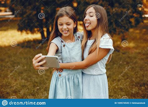 Two Cute Girls Have Fun In A Summer Park Stock Image Image Of Light