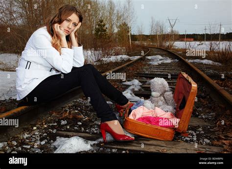 Blonde Girl Sitting On Rail Stock Photo Alamy