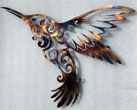 a metal humming bird with swirls on it s wings