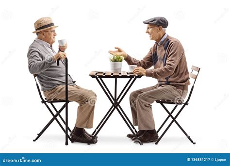 Two Senior Men Sitting At A Coffee Table And Talking Stock Image