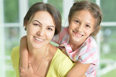 Portrait Of A Charming Little Girl Hugging With Mom At Home Stock Image