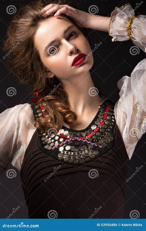 beautiful russian girl in national dress with a braid hairstyle and red lips beauty face stock