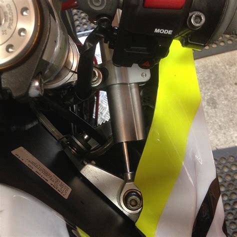 Firstly remove the small dust caps that can be seen on the top triple clamp on the bike. Harris Yamaha R6 Race Steering Damper Kit - Harris Performance