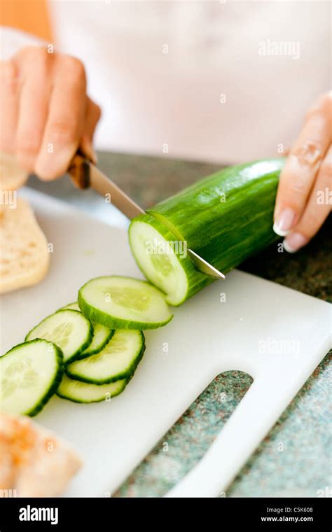 Woman Cutting Cucumber Stock Photo Alamy