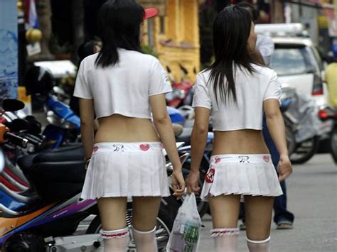 Two Bar Girls Walking Amoung The Many Beer Bars In Pattaya