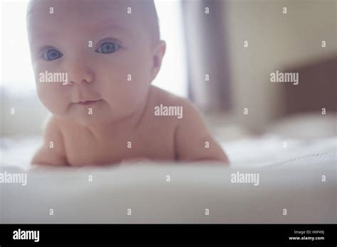 Close Up Portrait Of Cute Baby Lying In Bed At Home Stock Photo Alamy