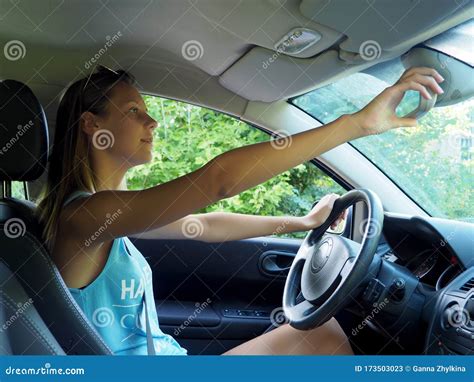 Woman Driving A Car Adjusts Rear View Mirror Stock Image Image Of