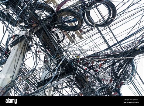 Tangled Electrical Wires On Urban Electric Pole Disorganized And Messy