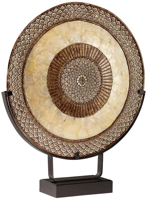 Add depth and personality to your home décor with this decorative accessory. Decorative Metal Medallion With Stand - | Formas