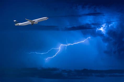 Commercial Airplane Take Off Flying Over Storm Clouds And Lightning