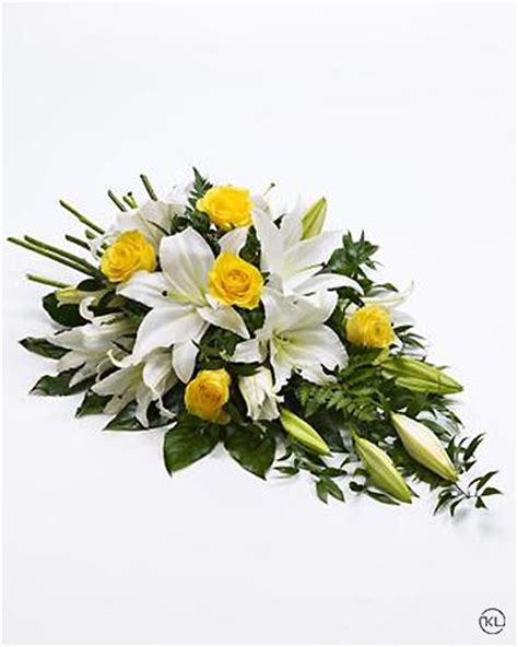 Download funeral flowers stock photos. Yellow Rose and White Lily Spray - Funeral Flowers London