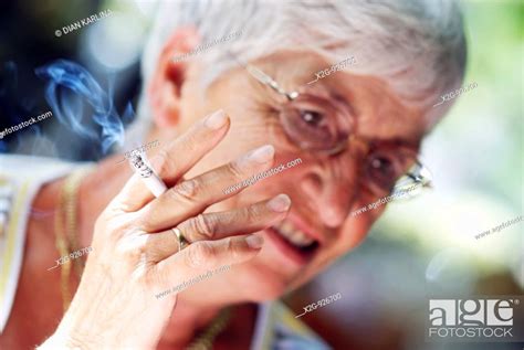 An Old Lady Smoking A Cigarette Stock Photo Picture And Rights