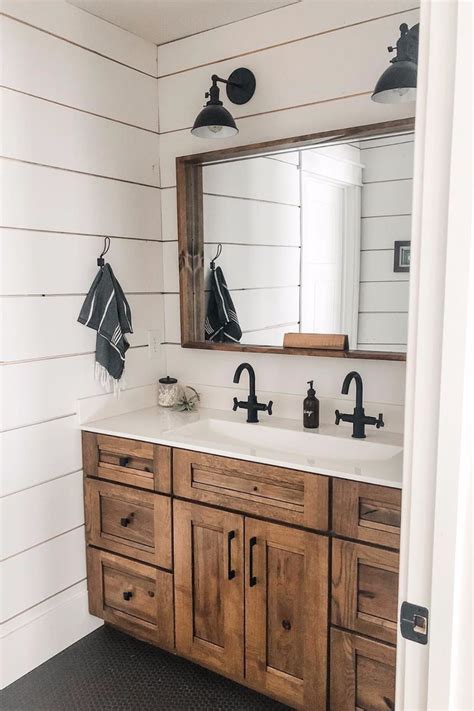 A Bathroom With Wooden Cabinets And White Walls