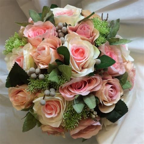 A Brides Bouquet Of Pink And Apricot Artificial Silk Rose Flowers