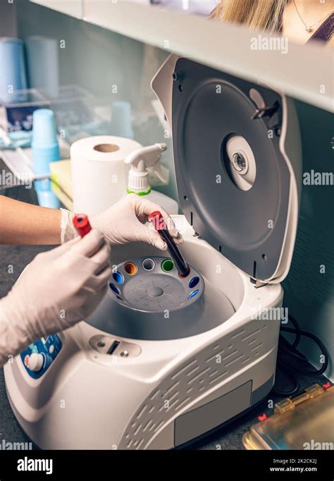 Nurse Put Blood Sample In Laboratory Centrifuge Stock Photo Alamy