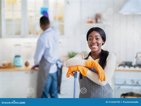 Portrait Of Happy African American Woman With Mop Ready For Cleanup