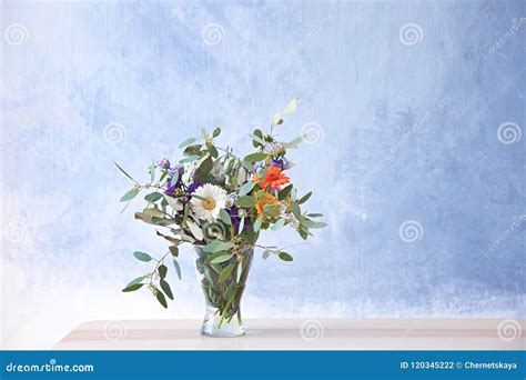 Beautiful Bouquet Of Flowers In Glass Vase On Blue Background Stock