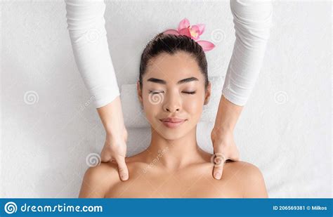 Spa Treatment Relaxed Asian Woman Getting Wellness Shoulder Massage By Professional Masseur