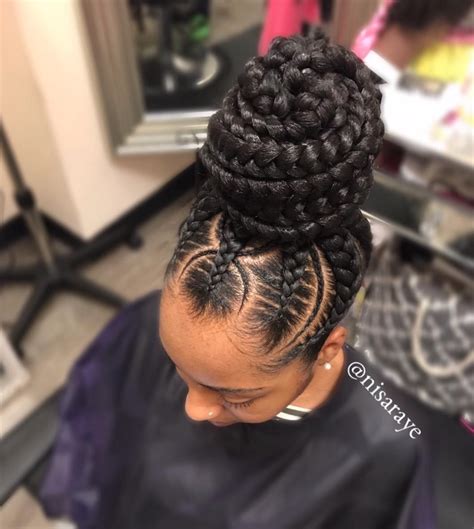 Using the hair itself to with braids working to control the front of the hair by sectioning and pulling back into a bun of braids, this look is very controlled. Flawless braided bun by @nisaraye - Black Hair Information