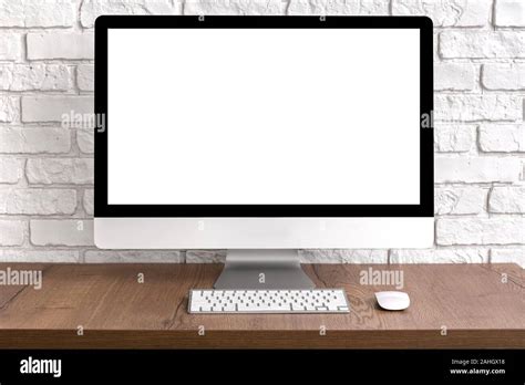 Mock Up Blank Screen Computer Desktop With Keyboard And Mouse On Wooden