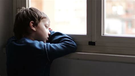 Child Sad And Lonely Looking Through Window Stock Footage Video 6178475