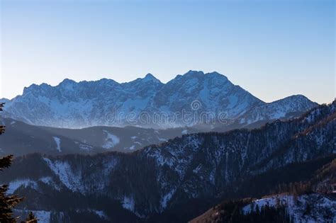 Early Morning View On Snow Capped Mountain Peaks Of Karawanks In