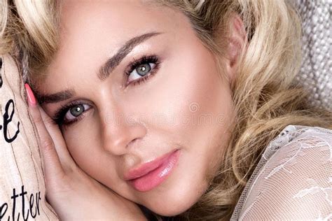 Portrait Beautiful Blonde Woman With A Beautiful Face And Amazing Eyes Lies Sleeps On The Bed