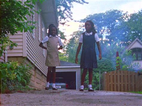Two Black Girls Running Down The Driveway Of Their Home Del