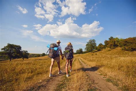 Hiking Couple With Backpack Walking On Hike In Nature Stock Photo